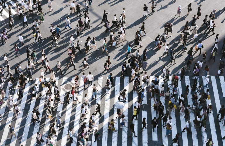 crowd of people crossing road in all directions
