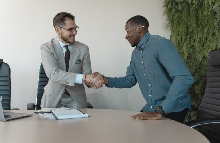 two men shaking hands at a job interview