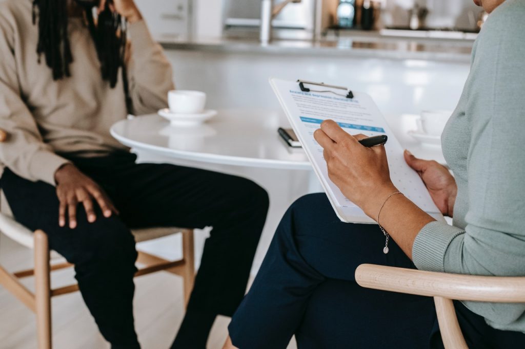 Two people sitting at a coffee shop table at a job interview