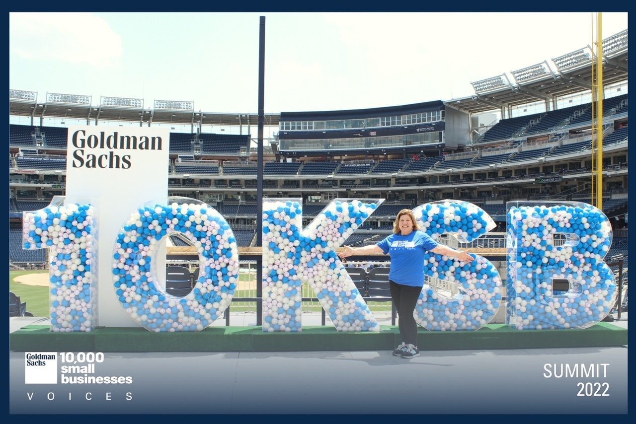 Jolene standing in front of sign reading Goldman Sachs 10K SB