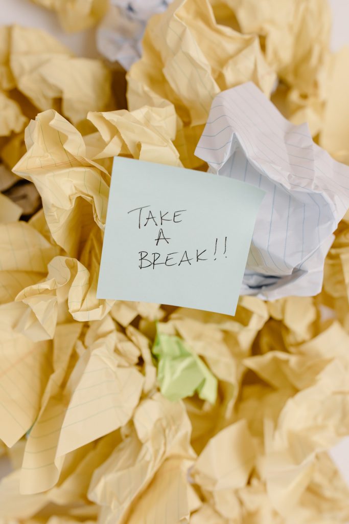 Crumpled paper with a post-it note that says, "Take a break." 