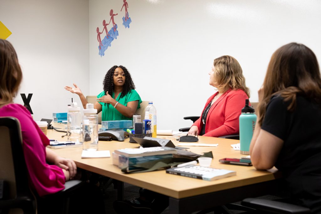 Risch Results team discussing at conference table