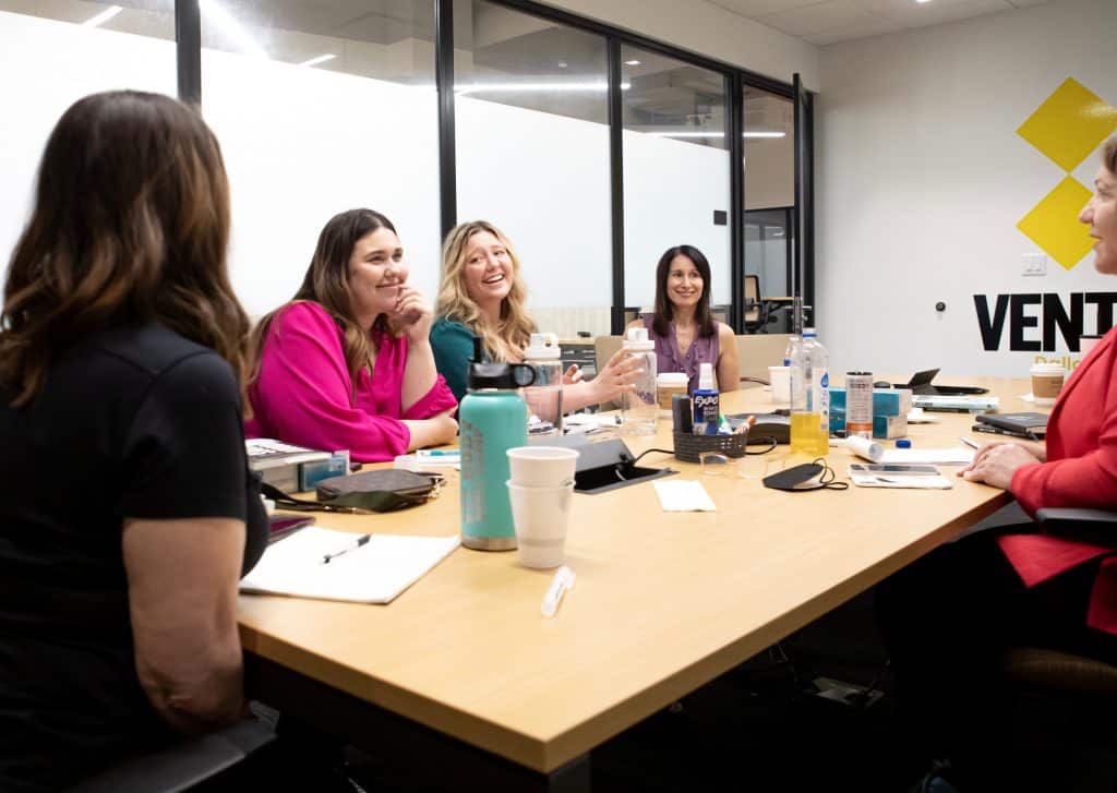 Risch Results Team having discussion at conference table.